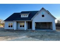 Charming single-story home with a large garage and covered porch, offering comfortable living at 6294 River Rd, Fuquay Varina, NC 27526