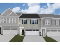Two-story townhome with neutral siding, two-car garage, and well-manicured lawn at 7127 Hubner Pl # 25, Cary, NC 27519
