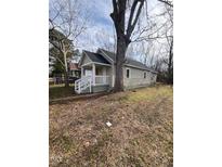 Tan house with white porch and railing, large tree in front yard at 715 Star St, Rocky Mount, NC 27804