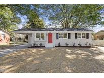 Newly renovated ranch home with a red door and landscaped yard at 732 Queens Ave, Dunn, NC 28334