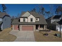 Two-story house with two-car garage, stone accents and solar panels at 897 Golden Plum Ln, Zebulon, NC 27597