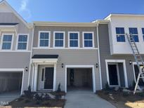 Charming townhouse featuring a one-car garage and modern facade at 107 Central Townes Way # 298, Raleigh, NC 27603