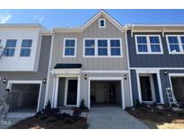 Charming townhome with a one-car garage and traditional architectural design at 115 Central Townes Way # 300, Raleigh, NC 27603