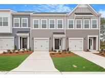Attractive townhomes with a pleasing color scheme, well-kept landscaping, and individual garages for each unit at 116 Fideaux Blvd # 258, Raleigh, NC 27603