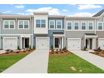 Charming townhomes featuring modern design, individual garages, and beautifully landscaped front yards at 120 Fideaux Blvd # 257, Raleigh, NC 27603