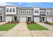 Charming townhomes with attached garages, lovely lawns, and neutral color schemes at 124 Fideaux Blvd # 256, Raleigh, NC 27603
