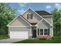 Two-story house with gray siding, white garage door, and landscaping at 142 Vega Loop, Sanford, NC 27330