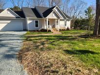 Charming single-Gathering home with a welcoming front porch and well-manicured lawn at 203 Brownville Ave, Hillsborough, NC 27278