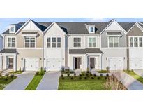 Charming townhomes featuring multiple stories, attached garages, and well-maintained landscaping at 21 Nettle Ln # 252, Clayton, NC 27520