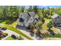 Beautiful two-story home featuring a manicured lawn, attached two car garage and classic architectural details at 3308 Eden Grove Rd, Fuquay Varina, NC 27526