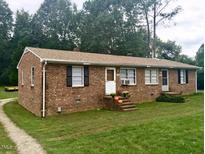 Brick duplex with two units, each with its own entrance and steps at 512 E Branch St, Spring Hope, NC 27882