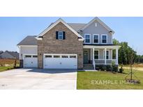 Two-story home with brick and siding exterior, two-car garage, and landscaped yard at 54 Cultivator Ct, Angier, NC 27501