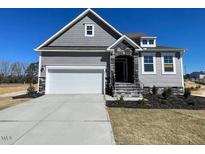Charming single-Gathering home with stone accents and a two-car garage at 82 N Stagecoach Dr, Wendell, NC 27591