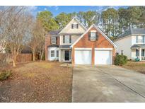 Brick two-story house with a two-car garage and a well-maintained lawn at 103 Burham Ct, Apex, NC 27502