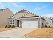 Charming single-Gathering home featuring stone accents, a two-car garage, and a well-manicured front lawn at 145 S Great White Way, Clayton, NC 27527