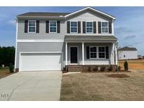 Charming two-story home featuring gray siding, a two-car garage, and a well-manicured front lawn at 178 Grove Township Way, Angier, NC 27501