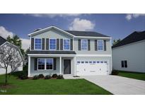 Two-story house with gray siding, white garage door, and landscaping at 178 Grove Township Way, Angier, NC 27501