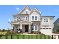 Two-story house with gray siding, stone accents, and a two-car garage at 204 E Fountainhead Ln, Garner, NC 27529