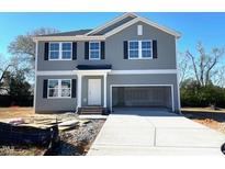 Two-story home features gray siding, black shutters, white trim, and an attached two-car garage at 211 Grove Township Way, Angier, NC 27501