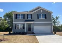 Two-story home with gray siding, a two-car garage, and a well-maintained front lawn at 211 Grove Township Way, Angier, NC 27501