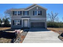 Two-story home with gray siding, a two-car garage, and a concrete driveway at 211 Grove Township Way, Angier, NC 27501