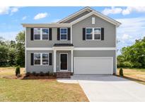 Charming two-story home with gray siding, black shutters, and a two-car garage at 211 Grove Township Way, Angier, NC 27501