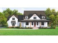 Two-story farmhouse with white siding, dark roof, and a covered front porch at 22 Slocum Dr, Wendell, NC 27591