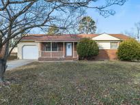 Brick ranch house with attached garage and front porch at 301 King Arthur Trl, Garner, NC 27529