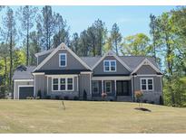 Charming craftsman home with gray siding, stone accents, and a well-manicured front yard at 3925 Cedar Knolls Dr, Youngsville, NC 27596