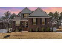 Charming brick home featuring manicured landscaping, a welcoming entrance, and a well-maintained lawn at 40 Ironwood Blvd, Youngsville, NC 27596