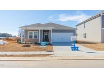 Gray house with white garage door and landscaping at 441 White Birch Ln, Angier, NC 27501
