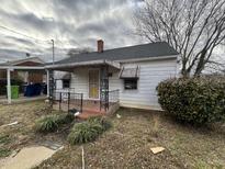 One-story house with front porch, mature trees, and a carport at 504 Coleman St, Raleigh, NC 27610