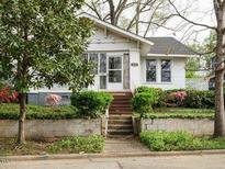 Charming home with a landscaped front yard and a welcoming entryway with stairs at 504 Washington St, Raleigh, NC 27605