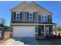 Charming two-story home with a spacious two-car garage and a well-manicured lawn at 14 E Victory View. Ter, Smithfield, NC 27577