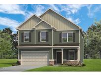 Two-story house with green siding, beige accents, and a two-car garage at 14 E Victory View. Ter, Smithfield, NC 27577