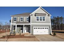 Charming two-story home featuring a two-car garage and classic gray siding at 25 Accord Dr, Youngsville, NC 27596