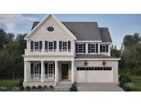 Two-story home with gray brick exterior, white trim, and a two-car garage at 2618 Marchmont St, Raleigh, NC 27608