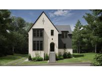 Two-story house with white brick and gray siding, a gabled roof, and a front porch at 2650 Marchmont Street St, Raleigh, NC 27608