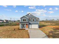 New construction two-story home with blue siding and an orange front door at 2995 Faucette Ln, Burlington, NC 27217