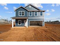 Two-story house with blue siding, attached garage, and small front yard at 2995 Faucette Ln, Burlington, NC 27217