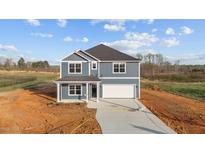 New two-story home boasts a modern design, attached garage, and a neatly paved driveway at 3615 Nc-62, Burlington, NC 27217