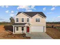 Charming two-story home featuring a classic design and a well-manicured front yard at 3649 Nc-62, Burlington, NC 27217