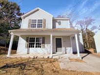 Two-story house with light gray siding, covered porch, and a landscaped yard at 3810 Chehaw Dr, Raleigh, NC 27610