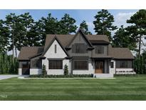 Two-story house with gray and white brick exterior, and a gabled roof at 3813 Peaceful Creek Trl, Zebulon, NC 27597