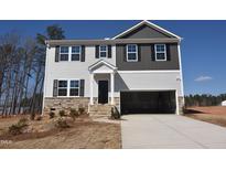 Two-story home boasts a gray and white exterior, accented by black shutters and a two-car garage at 60 Cordoba Dr, Franklinton, NC 27525