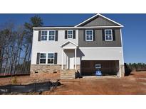 Two-story home featuring a stone-accented base, complementary siding, and an attached two-car garage at 60 Cordoba Dr, Franklinton, NC 27525