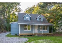 Charming blue house with a wood deck and well-maintained lawn at 621 Shepard School Rd, Zebulon, NC 27597