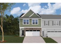 Two-story townhome with green siding, stone accents, and a two-car garage at 7125 Hubner Pl # 24, Cary, NC 27519