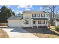 Two-story house with attached garage and landscaped yard at 717 E Holding Ave, Wake Forest, NC 27587