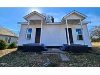 Front view of a charming white duplex with black accents and front porches at 1101-1103 N Anthony St, Burlington, NC 27217